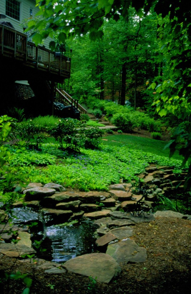 Inspiration for a large rustic drought-tolerant and partial sun hillside mulch water fountain landscape in DC Metro for spring.