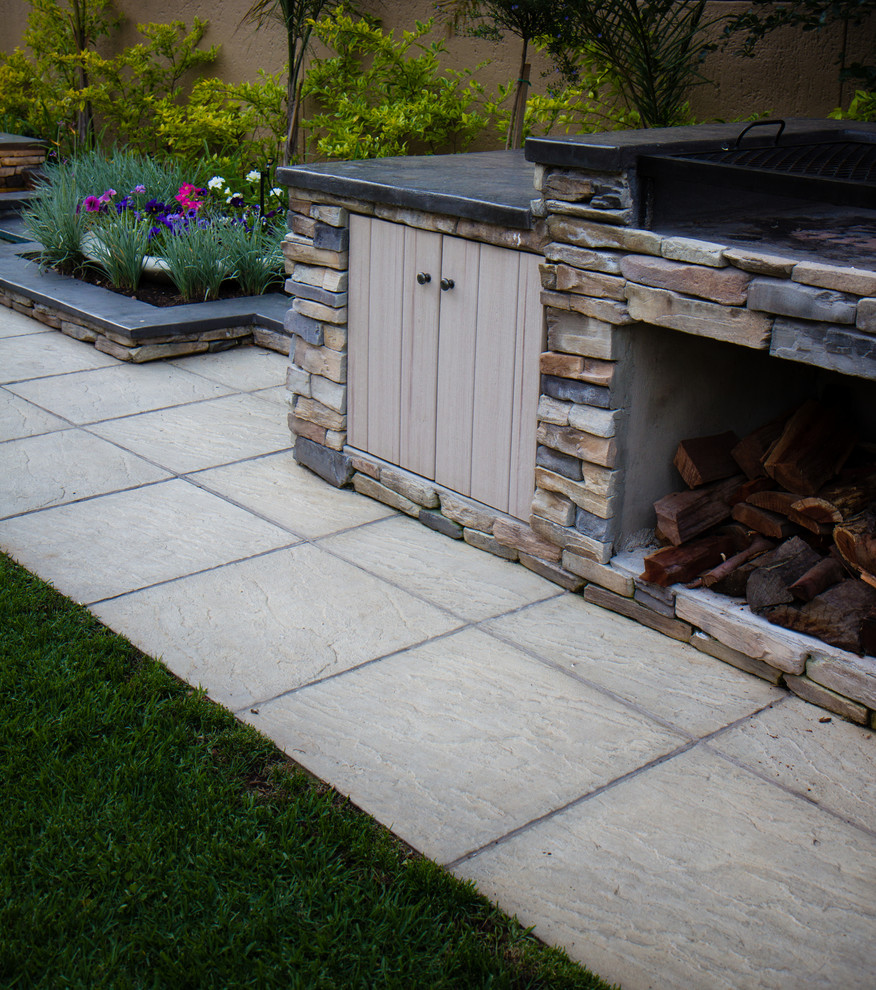 Inspiration for a rustic full sun backyard concrete paver landscaping.