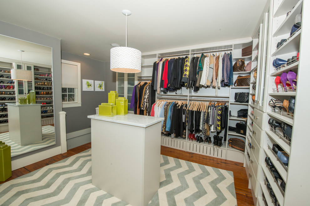 Photo of a contemporary women's dressing room in Philadelphia with white cabinets and light hardwood floors.