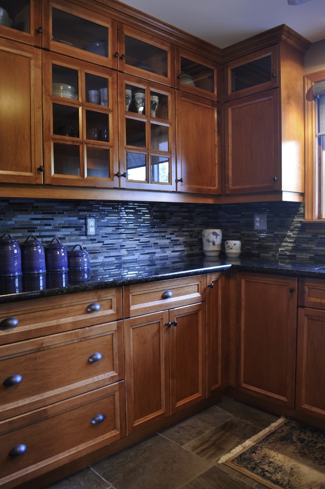 Mid-sized mountain style l-shaped kitchen photo in Toronto with an undermount sink, medium tone wood cabinets, granite countertops, blue backsplash, stainless steel appliances and no island
