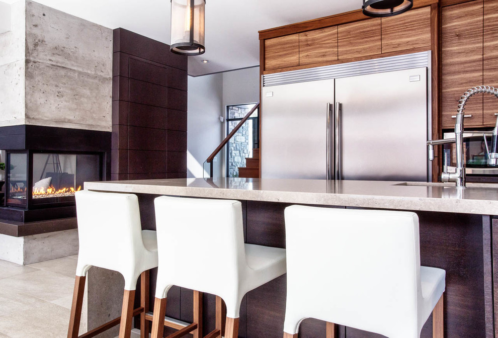 Photo of an expansive contemporary eat-in kitchen in Toronto with an undermount sink, flat-panel cabinets, light wood cabinets and stainless steel appliances.