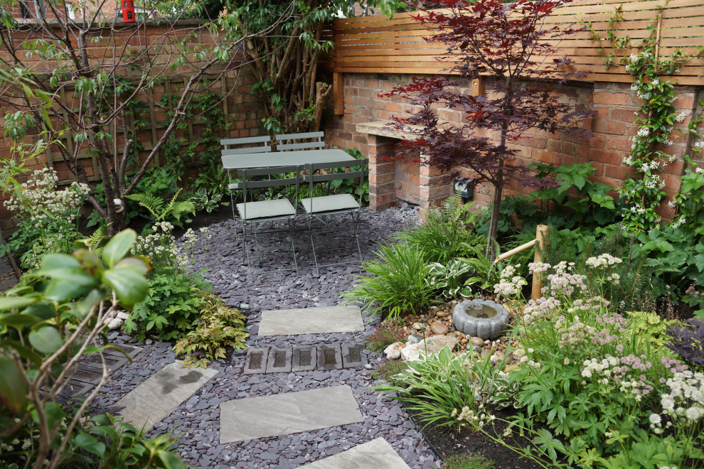 Photo of a small asian full sun backyard stone landscaping in West Midlands.
