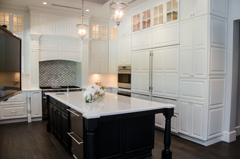 Example of a large transitional u-shaped enclosed kitchen design in Miami with a farmhouse sink, raised-panel cabinets, white cabinets, quartz countertops, gray backsplash, porcelain backsplash, paneled appliances and an island