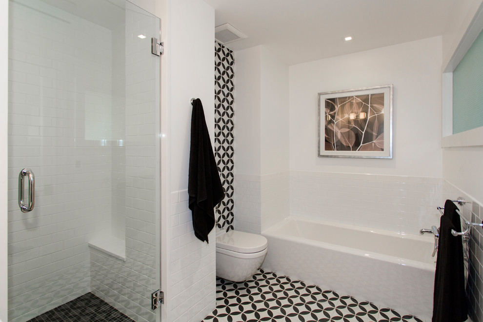 Inspiration for a modern master wet room bathroom in New York with an alcove tub, a one-piece toilet, white tile, white walls, multi-coloured floor and a hinged shower door.