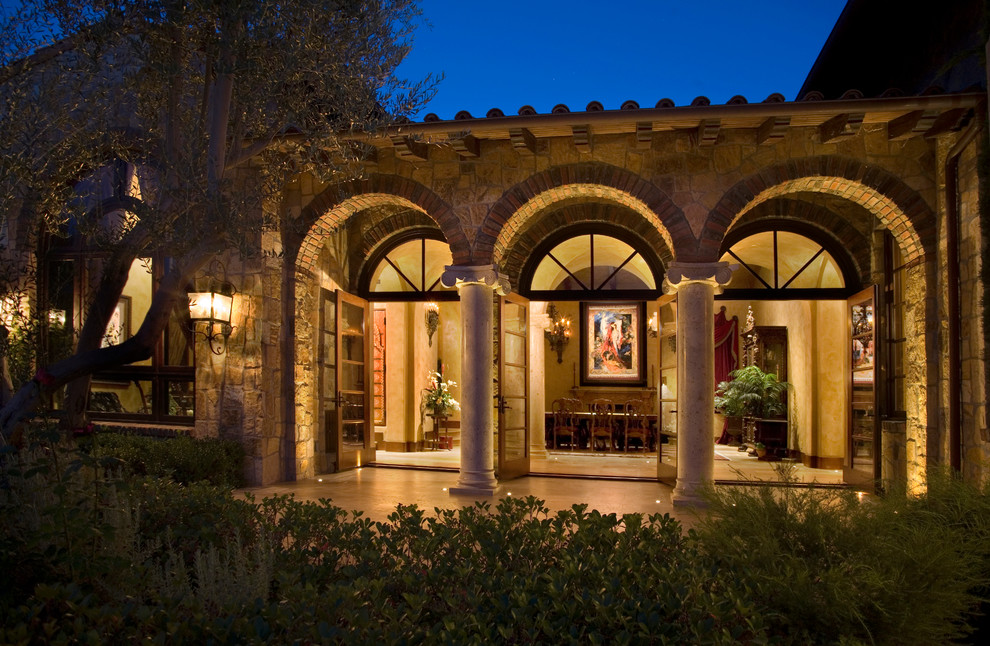 Inspiration for a mediterranean exterior in Orange County with stone veneer.