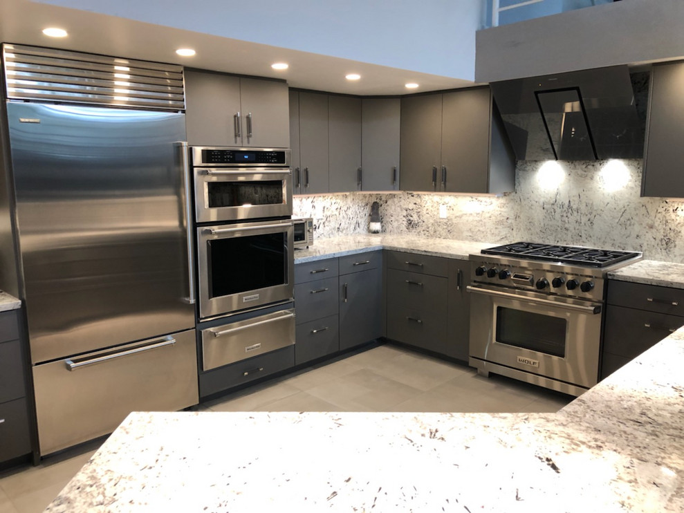 This is an example of a large modern u-shaped kitchen/diner in Phoenix with a built-in sink, flat-panel cabinets, grey cabinets, granite worktops, multi-coloured splashback, granite splashback, stainless steel appliances, porcelain flooring, an island, beige floors and multicoloured worktops.