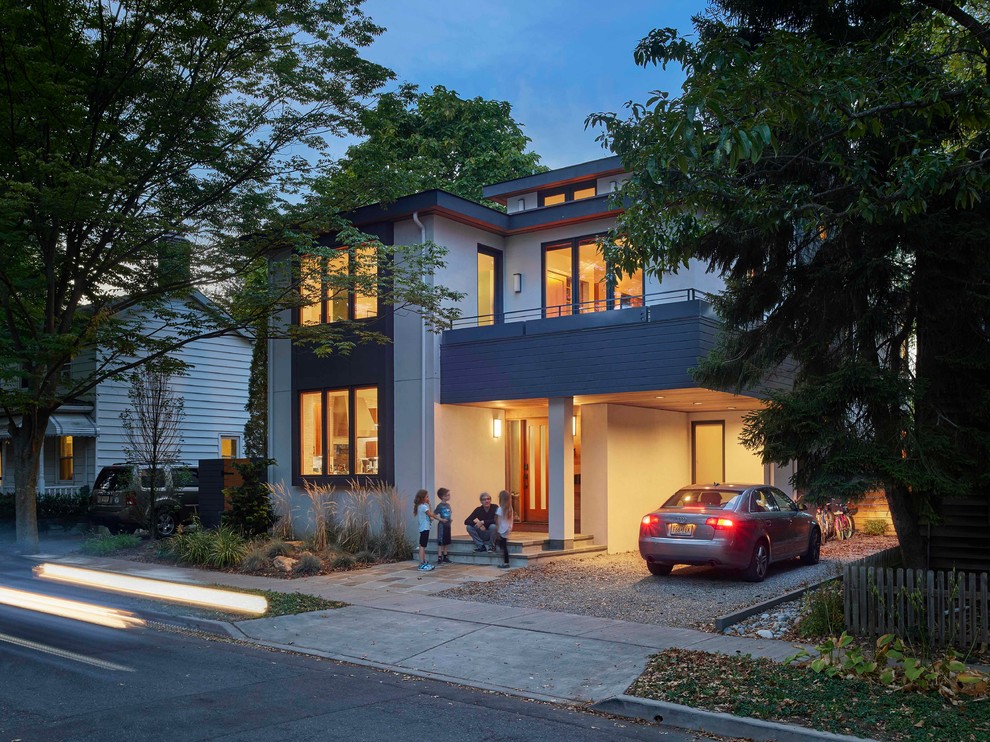 Mid-sized contemporary two-storey stucco white house exterior in Philadelphia with a hip roof and a shingle roof.