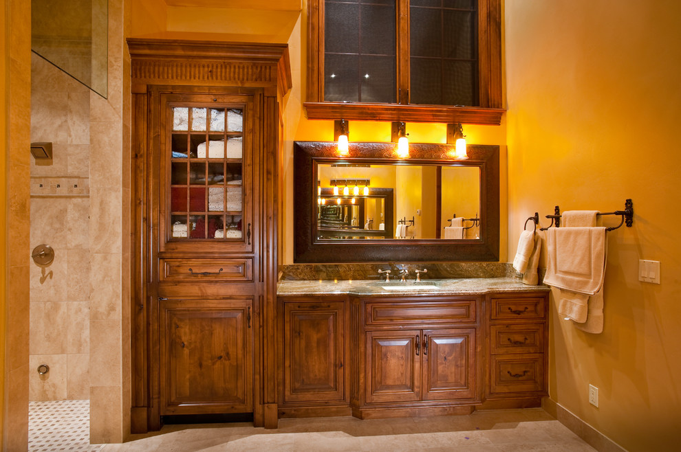 Large country master bathroom in Denver with an undermount sink, furniture-like cabinets, medium wood cabinets, granite benchtops, a corner shower, beige tile, stone tile, beige walls, limestone floors, beige floor, an open shower, white benchtops and a single vanity.