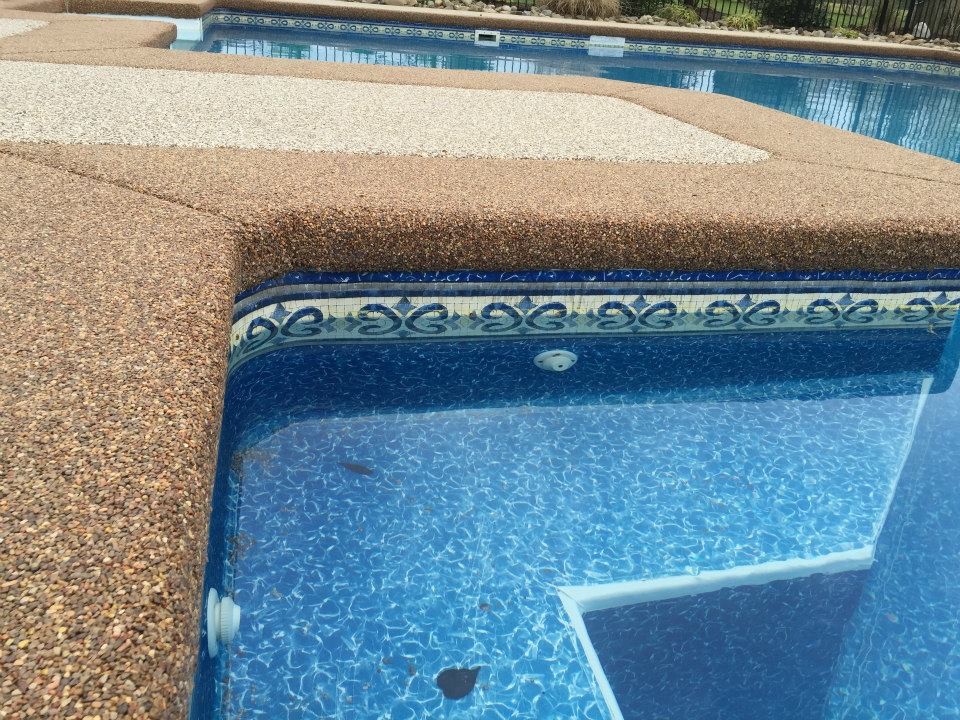 Mid-sized transitional backyard concrete and custom-shaped pool photo