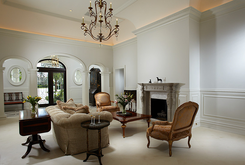 Photo of a traditional formal living room in Miami with white walls, a standard fireplace and a tile fireplace surround.