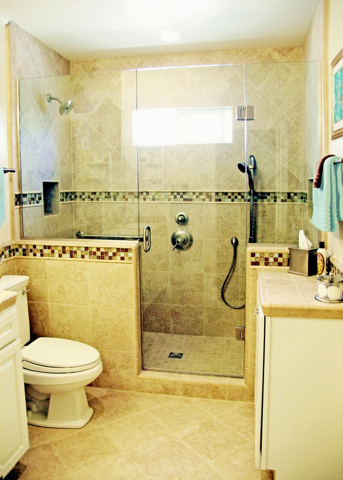 Inspiration for a small transitional 3/4 bathroom in Los Angeles with raised-panel cabinets, white cabinets, tile benchtops, an alcove shower, a two-piece toilet, beige tile, porcelain tile, beige walls and porcelain floors.