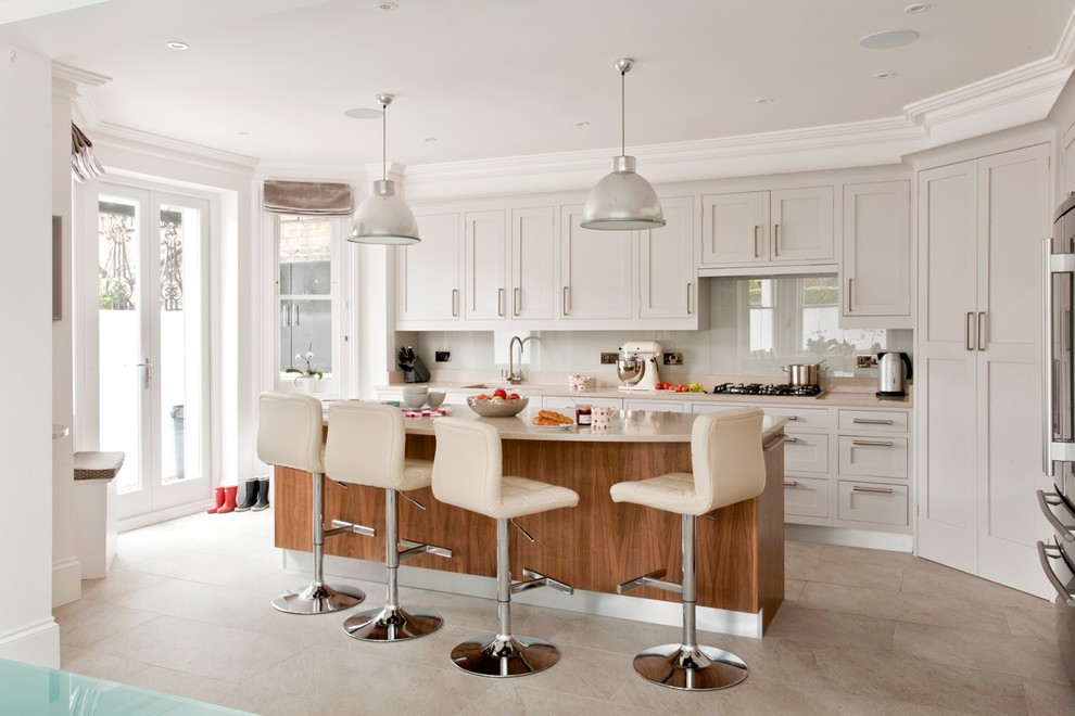 Design ideas for a classic l-shaped kitchen in London with shaker cabinets, grey cabinets, grey splashback, glass sheet splashback, stainless steel appliances and an island.