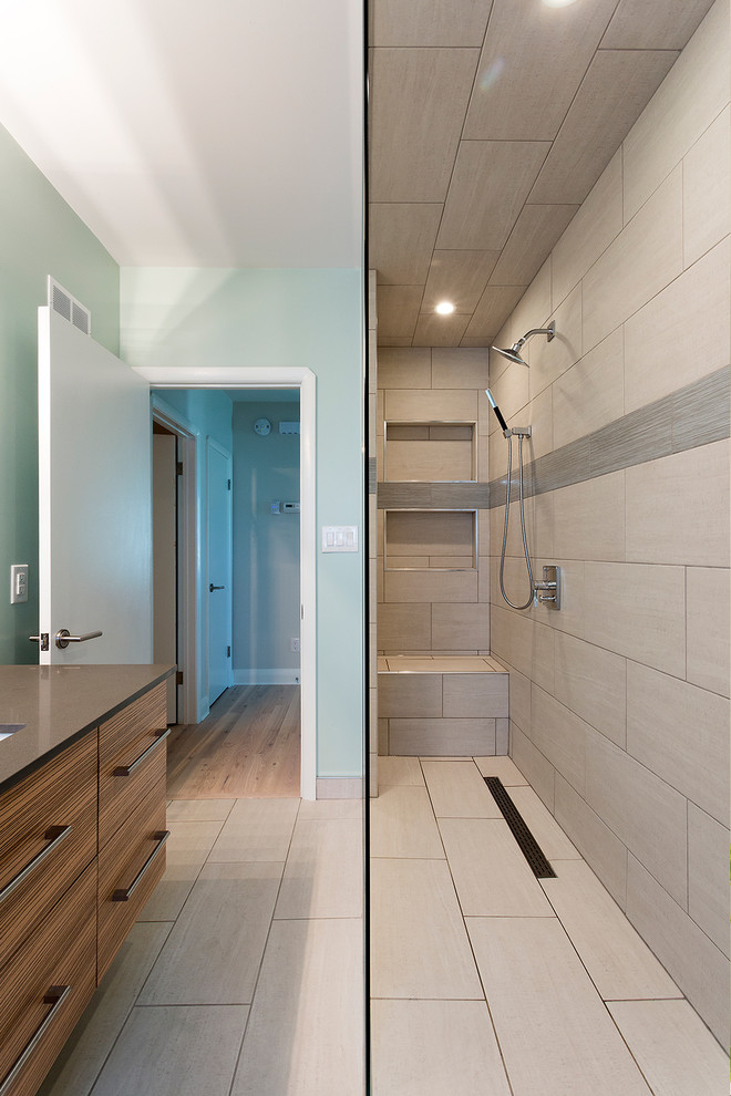 This is an example of a mid-sized modern 3/4 bathroom in Other with an undermount sink, medium wood cabinets, an open shower, beige tile, beige walls, flat-panel cabinets, a two-piece toilet, porcelain tile, porcelain floors and soapstone benchtops.