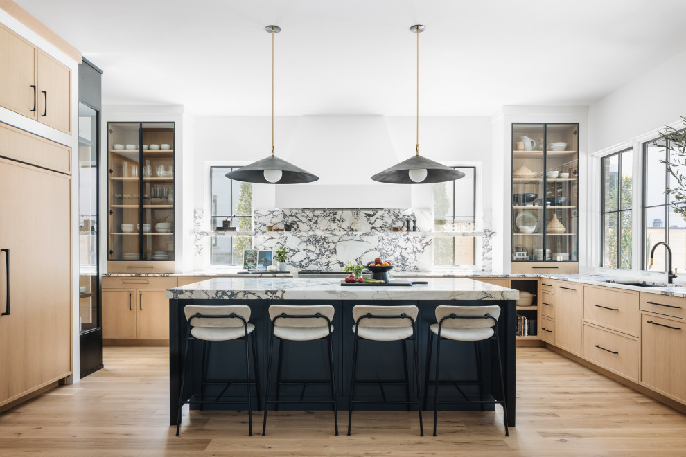Inspiration for a transitional u-shaped open plan kitchen in Chicago with an undermount sink, shaker cabinets, medium wood cabinets, granite benchtops, multi-coloured splashback, panelled appliances, medium hardwood floors, with island and brown floor.
