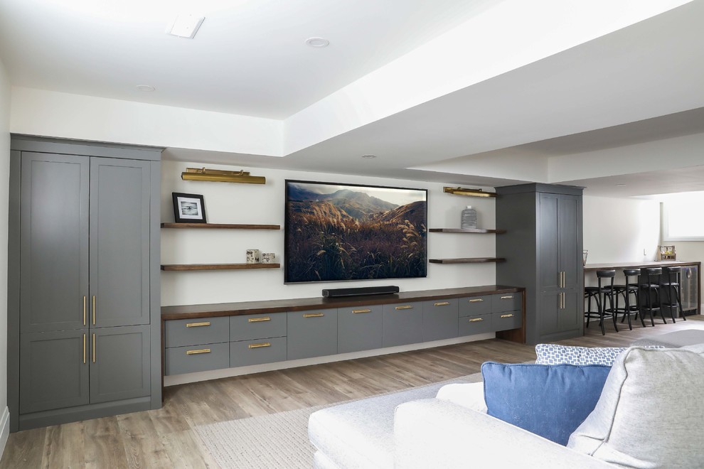 Example of a large transitional look-out vinyl floor and brown floor basement design with white walls