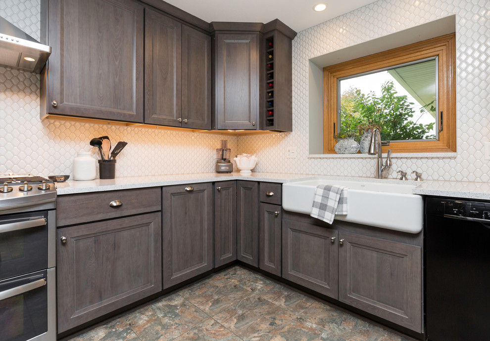 Inspiration for a mid-sized transitional l-shaped vinyl floor and gray floor eat-in kitchen remodel with a farmhouse sink, recessed-panel cabinets, gray cabinets, quartz countertops, white backsplash, ceramic backsplash, stainless steel appliances, no island and white countertops