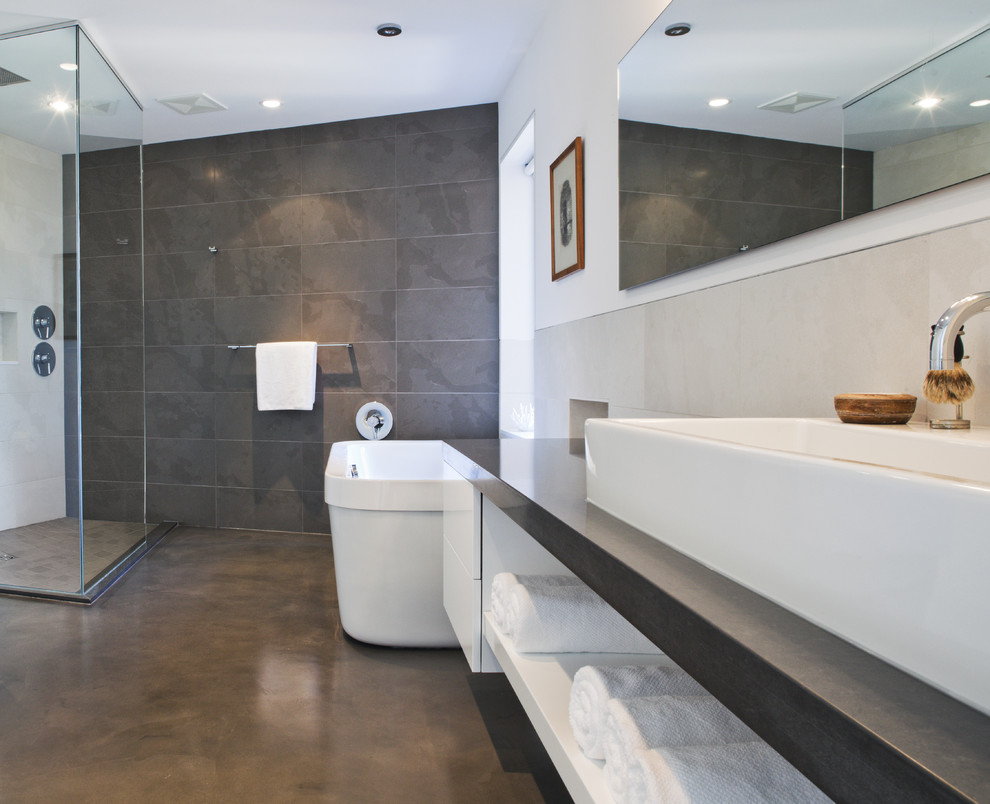 Inspiration for a modern bathroom in Vancouver with a freestanding tub, a vessel sink, concrete floors, an open shower, an open shower and slate.