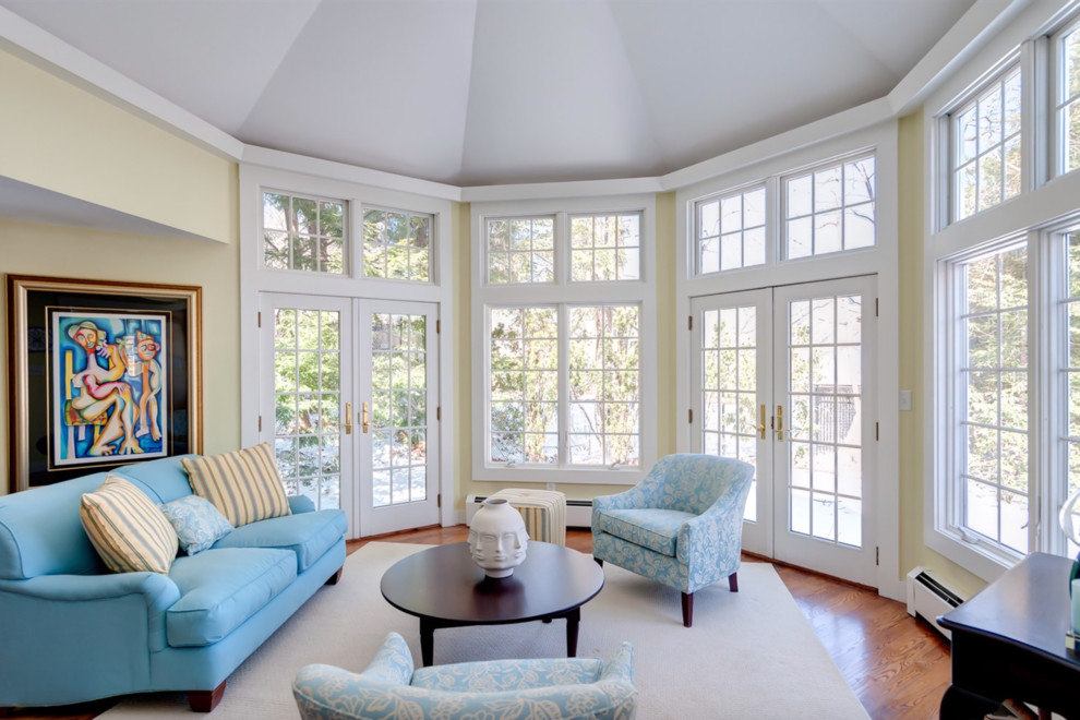 Design ideas for a large transitional sunroom in Boston with medium hardwood floors, a standard ceiling and beige floor.