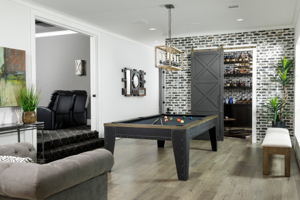 Large transitional enclosed family room in Houston with white walls, laminate floors, grey floor, a game room and brick walls.