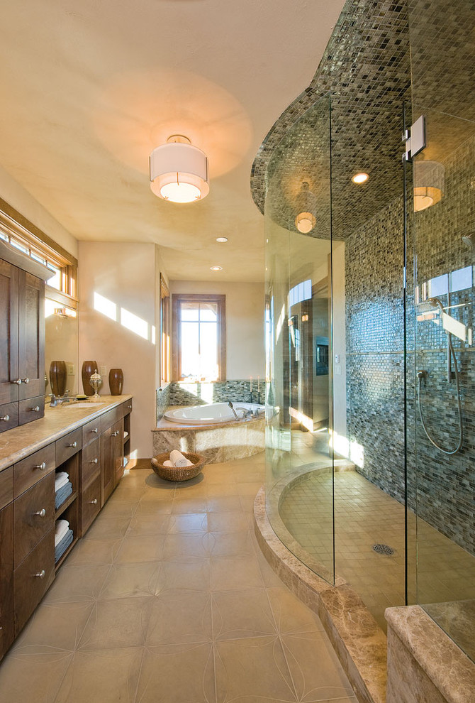 Large contemporary master bathroom in Denver with flat-panel cabinets, dark wood cabinets, terrazzo benchtops, a corner tub, an open shower, multi-coloured tile, glass tile, beige walls, ceramic floors and an undermount sink.