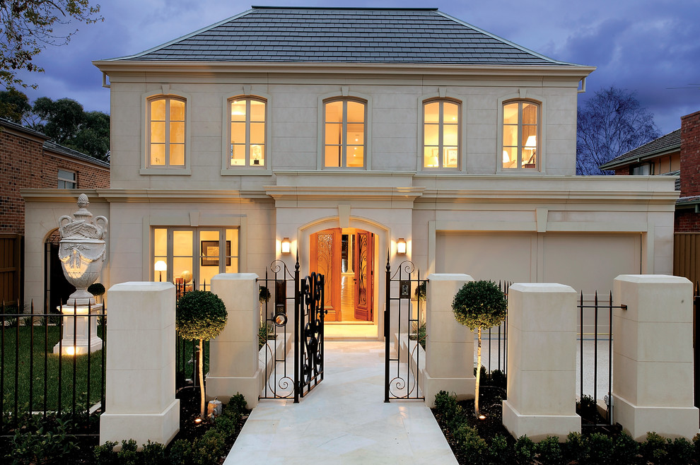 This is an example of a traditional two-storey beige exterior in Melbourne with a hip roof.