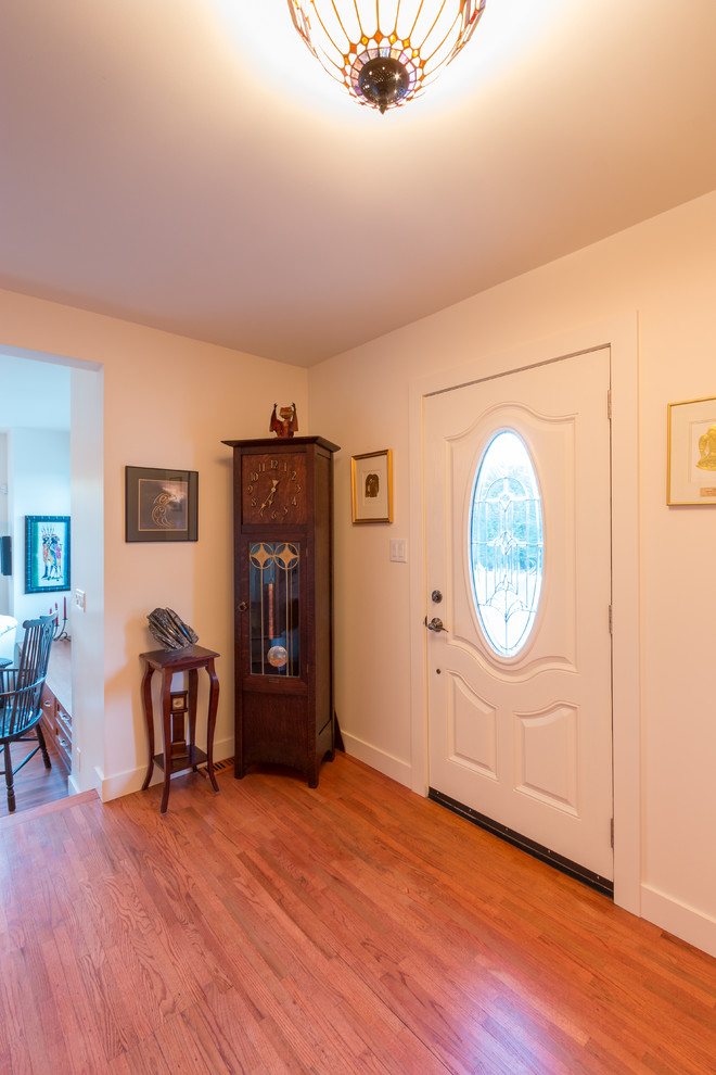 Mid-sized traditional foyer in Vancouver with white walls, medium hardwood floors, a single front door and a white front door.