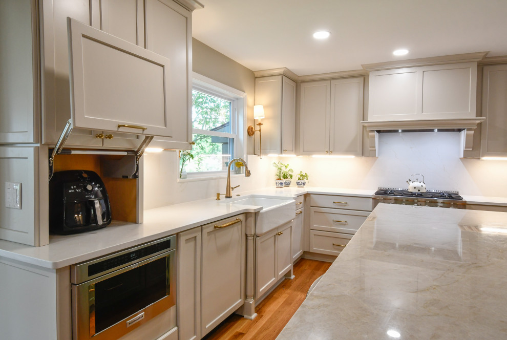 Example of a huge transitional u-shaped enclosed kitchen design in DC Metro with a farmhouse sink, recessed-panel cabinets, quartz countertops, white backsplash, quartz backsplash, stainless steel appliances, an island and white countertops
