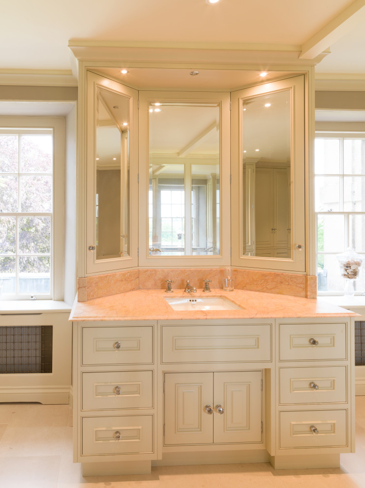 This is an example of a large traditional master bathroom in Other with recessed-panel cabinets, green cabinets, a freestanding tub, an open shower, a one-piece toilet, white tile, limestone, limestone floors, an integrated sink, marble benchtops, white floor, an open shower, red benchtops, a single vanity and a freestanding vanity.
