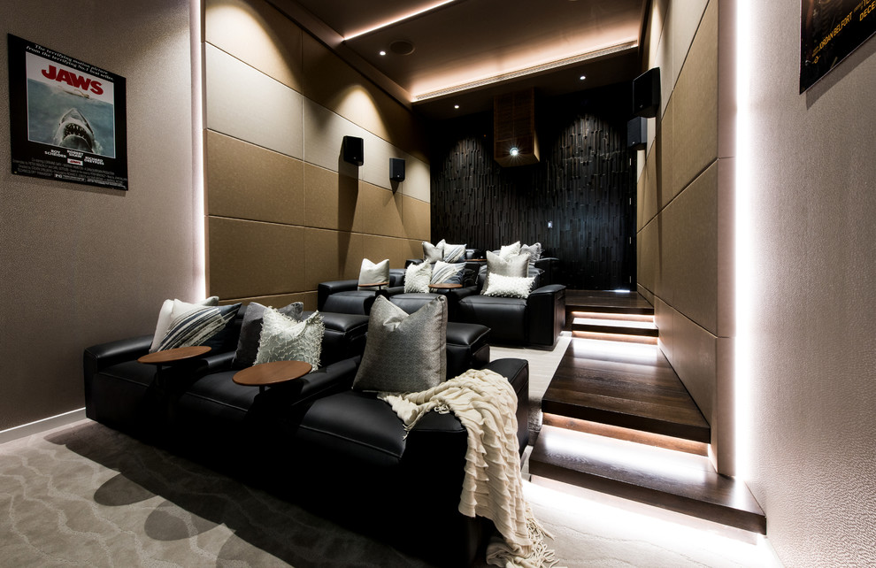 This is an example of a large contemporary enclosed home theatre in Sunshine Coast with beige walls, carpet and beige floor.