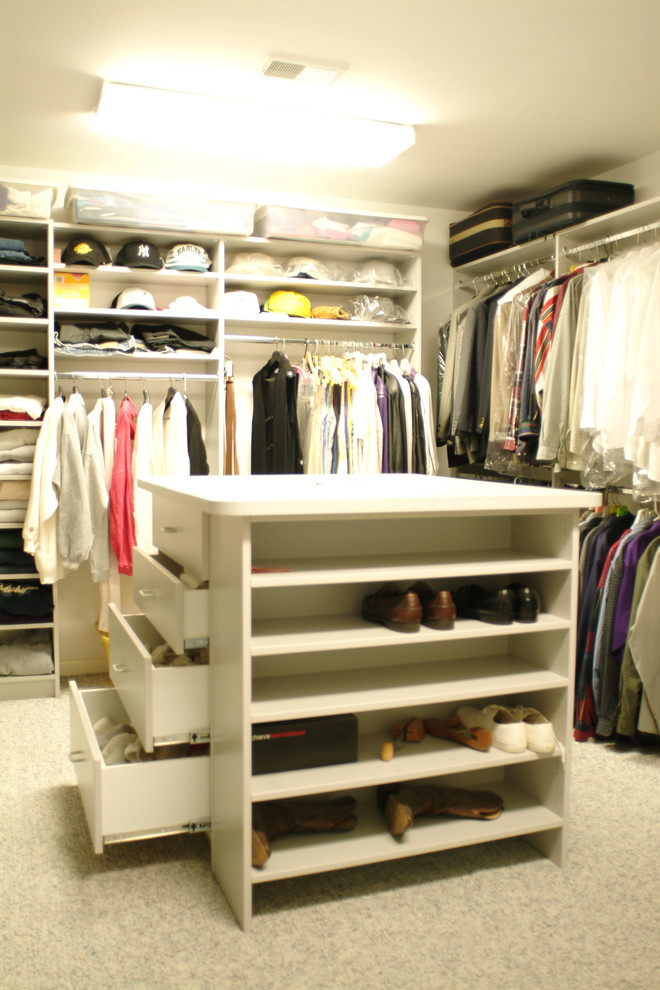 Design ideas for a large traditional men's walk-in wardrobe in New York with open cabinets, white cabinets and carpet.