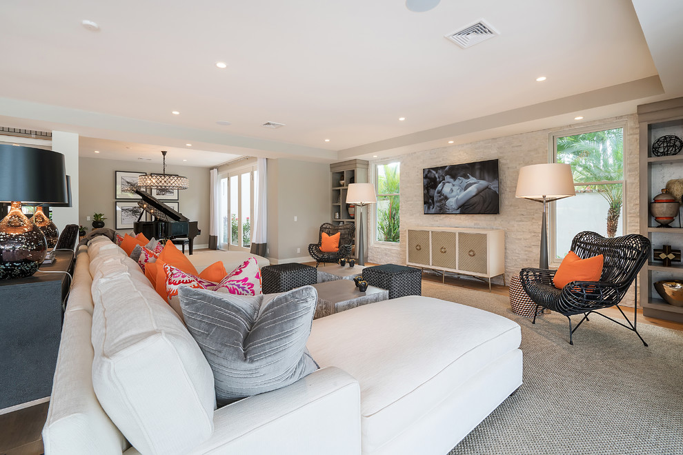Inspiration for a mid-sized transitional open concept living room in Orange County with brown walls, medium hardwood floors, a wall-mounted tv and brown floor.