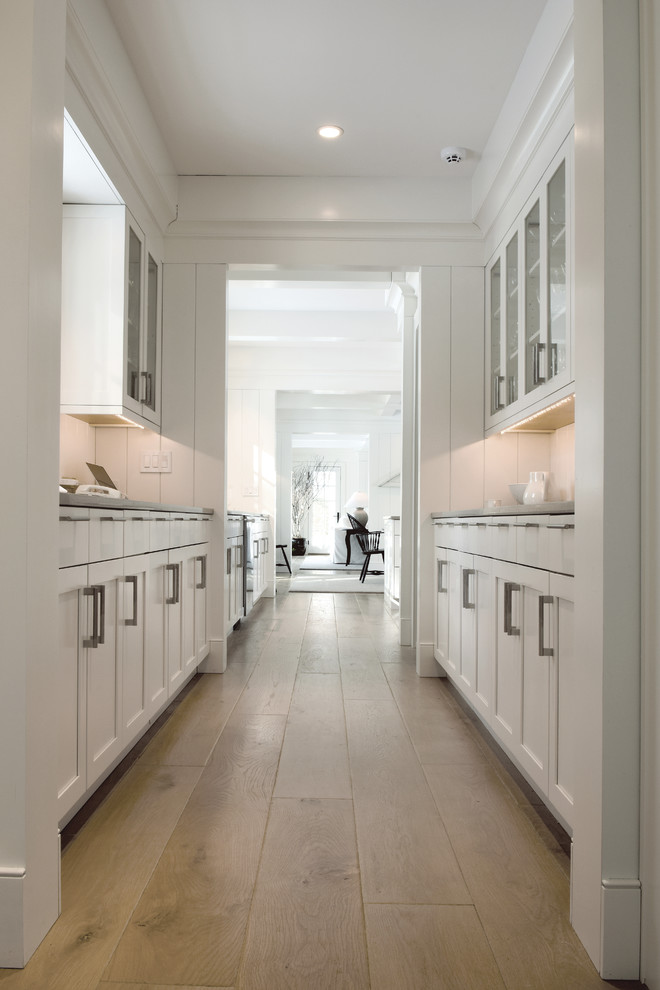 Large scandinavian galley eat-in kitchen in Chicago with an undermount sink, shaker cabinets, white cabinets, quartzite benchtops, white splashback, subway tile splashback, stainless steel appliances, medium hardwood floors, with island, brown floor, grey benchtop and coffered.