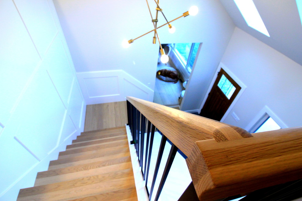 Inspiration for a large transitional wooden l-shaped mixed material railing staircase remodel with painted risers