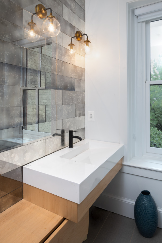 Design ideas for a mid-sized transitional bathroom in DC Metro with flat-panel cabinets, medium wood cabinets, gray tile, mirror tile, an undermount sink, white benchtops, a single vanity, a built-in vanity, white walls, grey floor and an alcove tub.