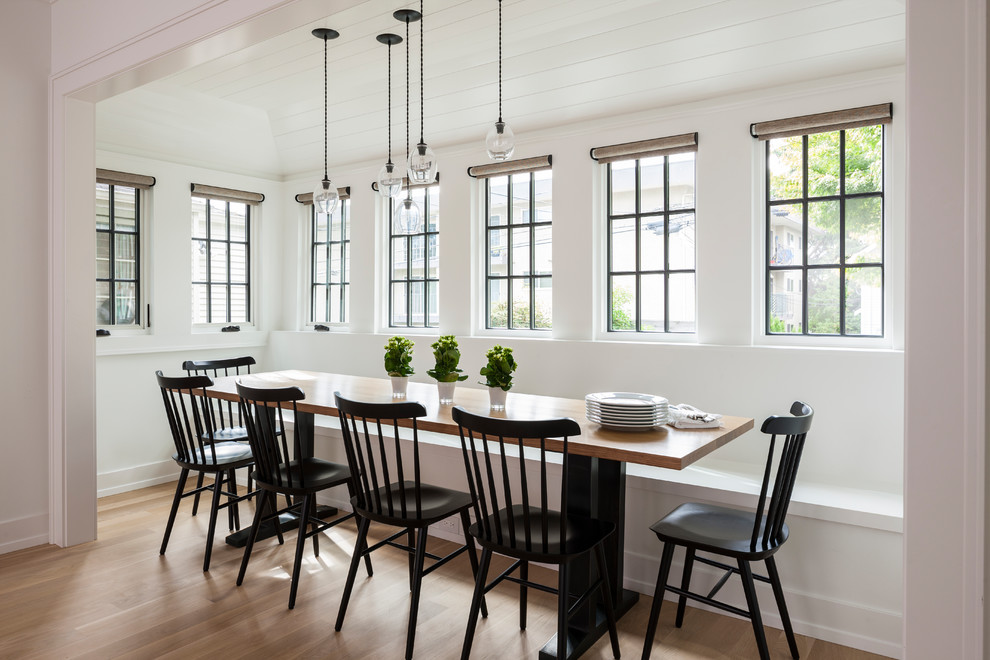 Example of a mid-sized transitional light wood floor and beige floor great room design in Seattle with white walls and no fireplace