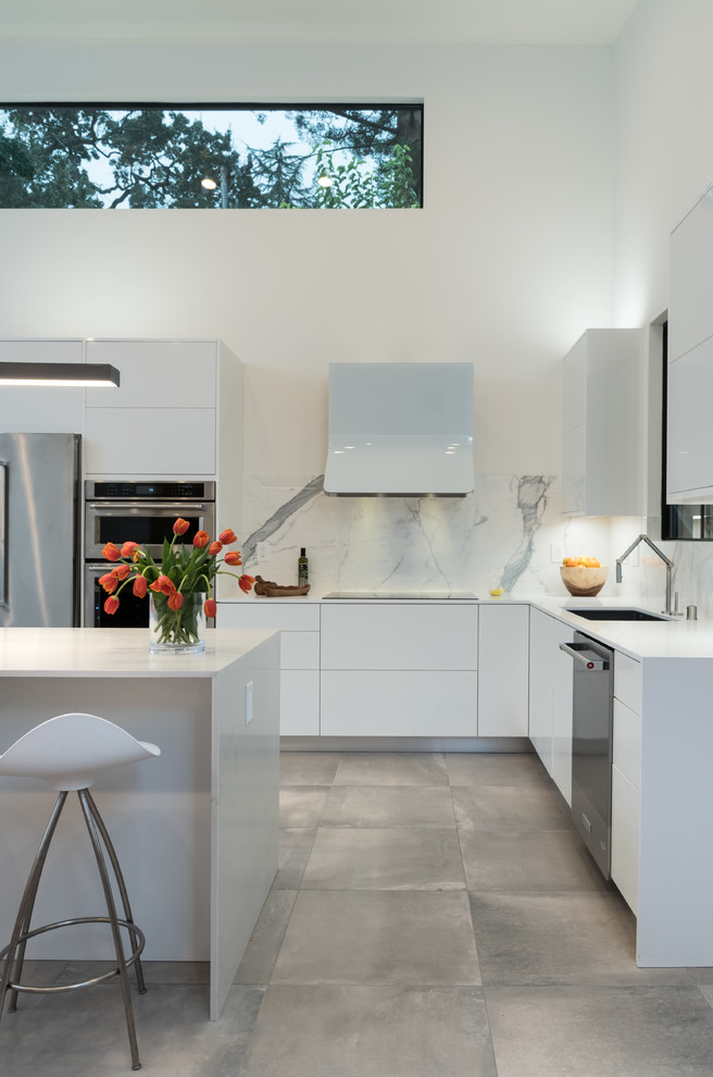 This is an example of a contemporary l-shaped kitchen in San Francisco with an undermount sink, flat-panel cabinets, white cabinets, multi-coloured splashback, stainless steel appliances and with island.