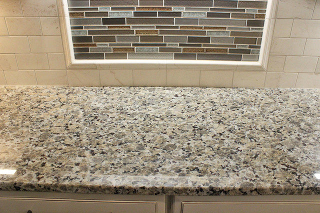 Beige Kitchen With Extra Large Island Tile Backsplash And Granite
