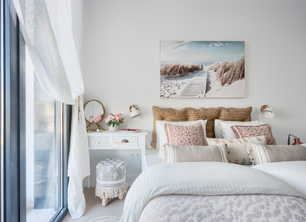 Small mediterranean guest bedroom in Other with white walls, porcelain floors and beige floor.