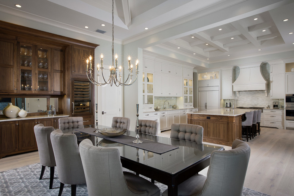 Transitional light wood floor open concept kitchen photo with stainless steel appliances and an island