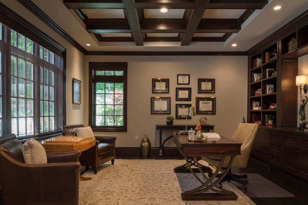 This is an example of a mid-sized traditional home office in Other with beige walls, dark hardwood floors, no fireplace and a freestanding desk.