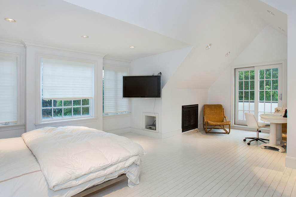 Inspiration for a large transitional guest bedroom in New York with white walls, painted wood floors, a standard fireplace and a metal fireplace surround.