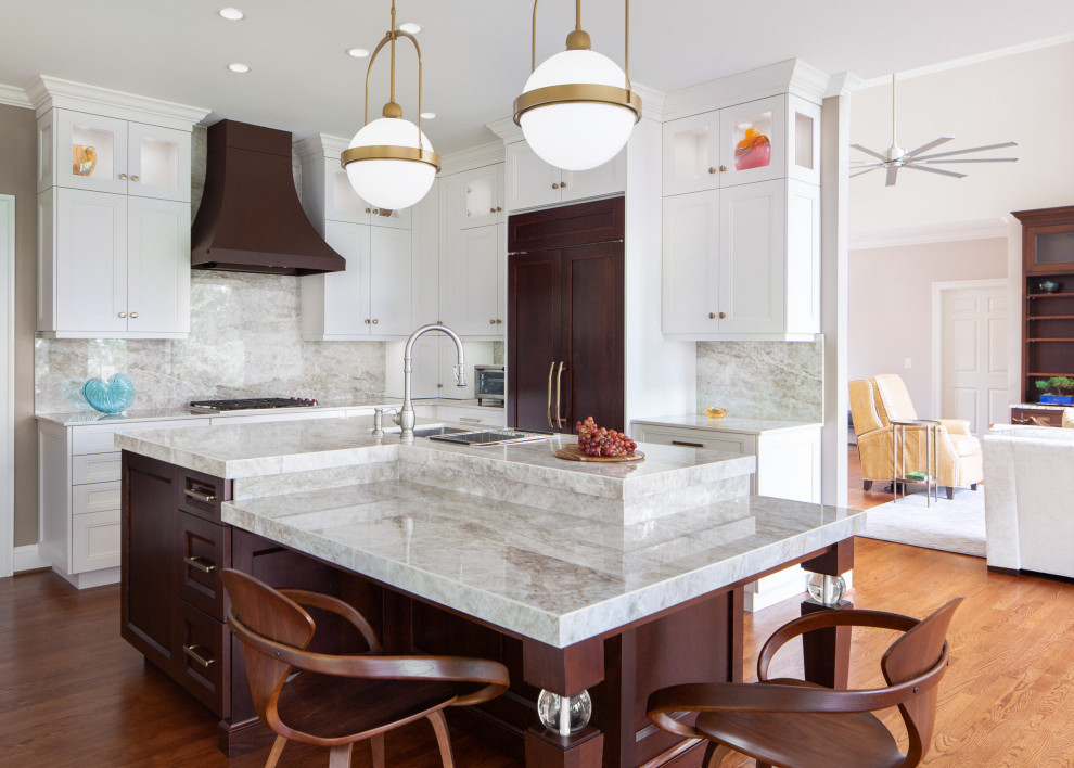 Eat-in kitchen - large transitional u-shaped dark wood floor and brown floor eat-in kitchen idea in Raleigh with an undermount sink, recessed-panel cabinets, quartz countertops, beige backsplash, quartz backsplash, paneled appliances, an island, beige countertops and white cabinets