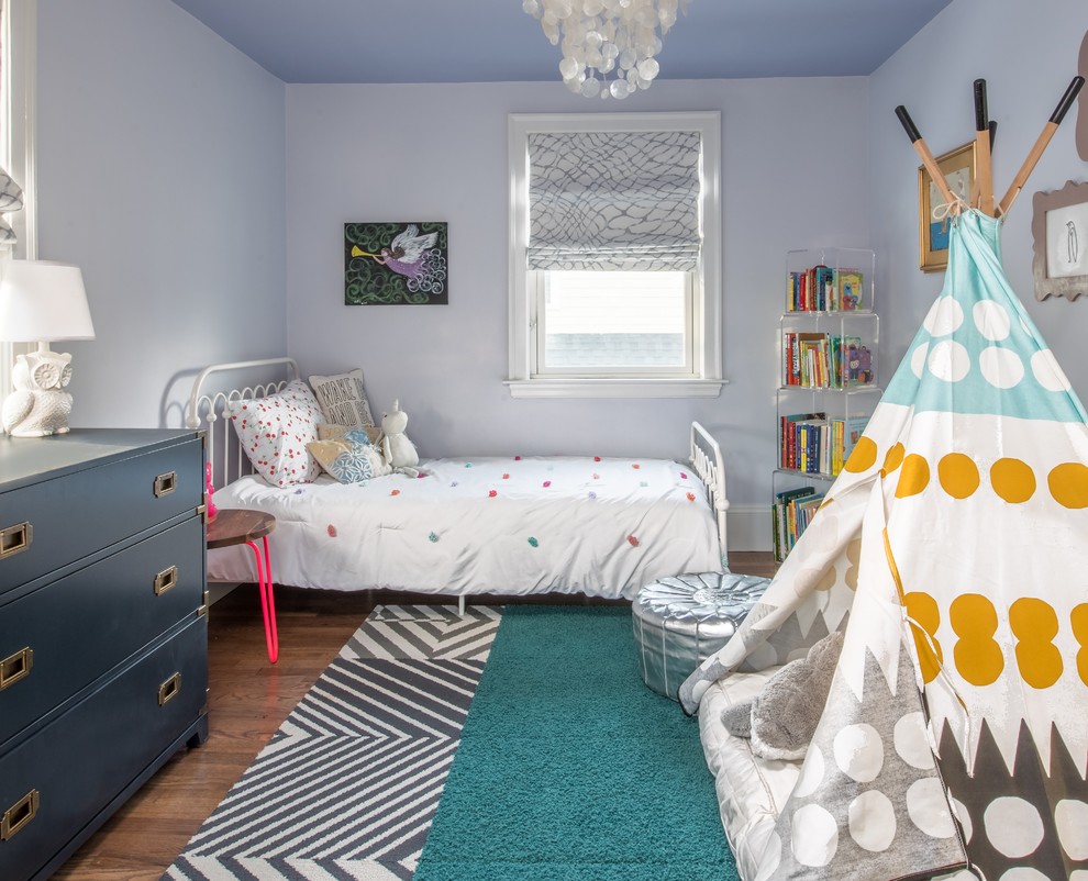 Mid-sized transitional girl medium tone wood floor and brown floor kids' room photo in Boston with blue walls