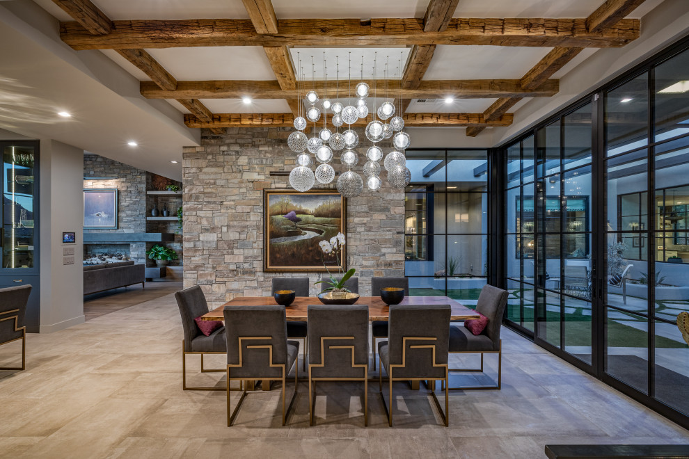 This is an example of a contemporary open plan dining in Salt Lake City with grey walls, grey floor and exposed beam.