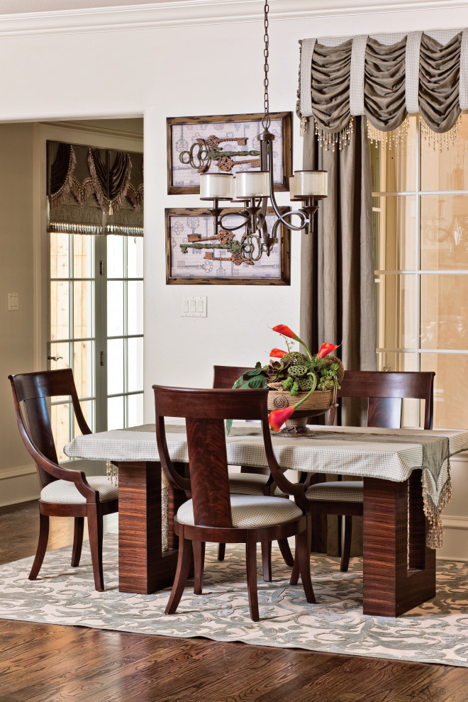 This is an example of a traditional kitchen/dining combo in Dallas with grey walls, medium hardwood floors and brown floor.