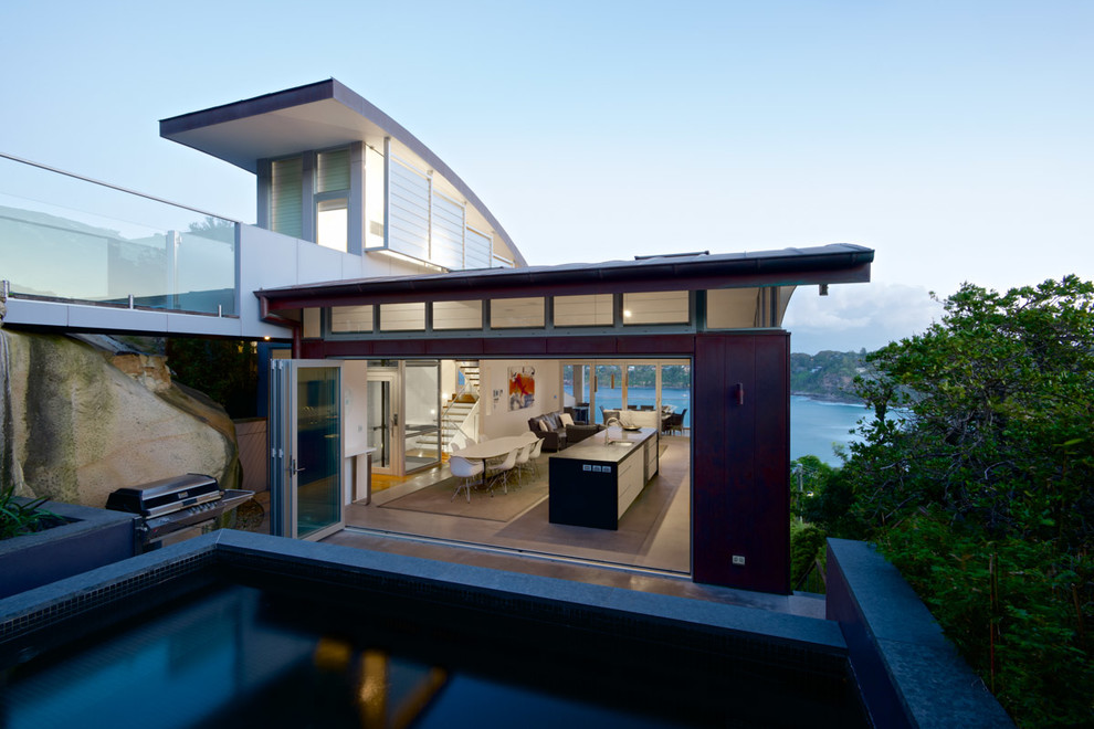 This is an example of a mid-sized contemporary backyard rectangular aboveground pool in Sydney with concrete slab.