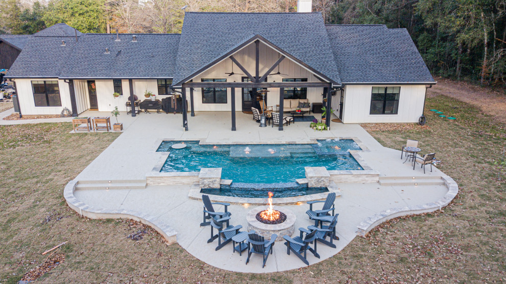 Photo of a large country backyard rectangular pool in Houston with decking.
