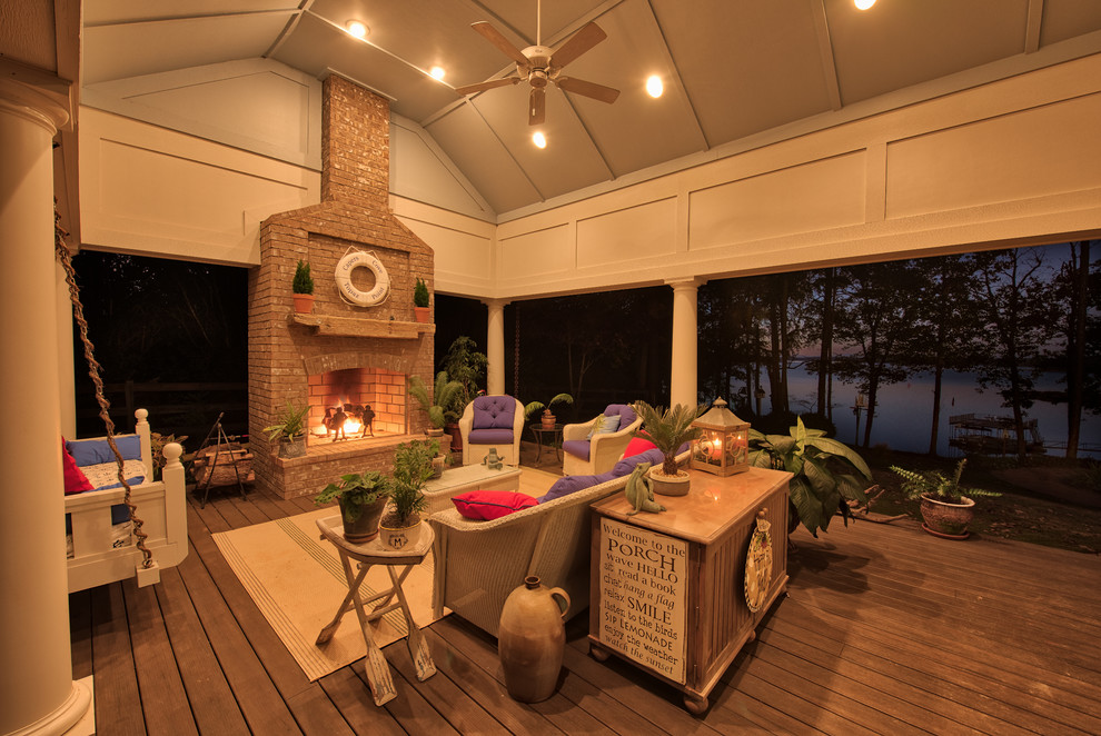 Large transitional backyard verandah in Other with a fire feature and brick pavers.