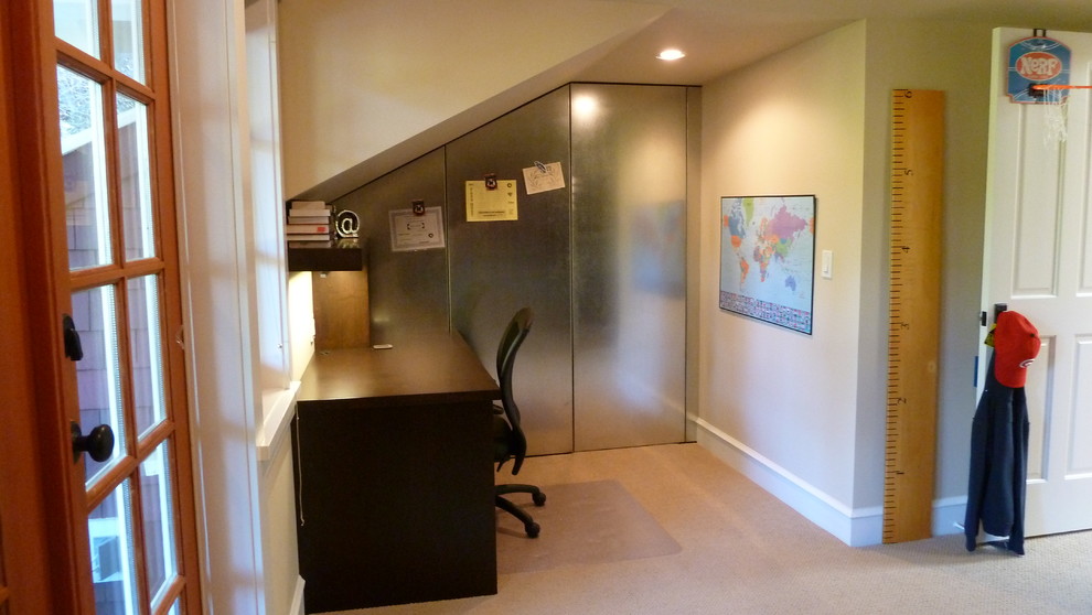 This is an example of a mid-sized arts and crafts study room in Vancouver with beige walls, carpet and a freestanding desk.