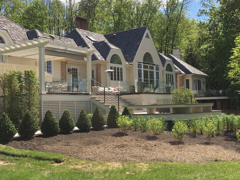 Design ideas for an expansive contemporary backyard deck in Philadelphia with a pergola.